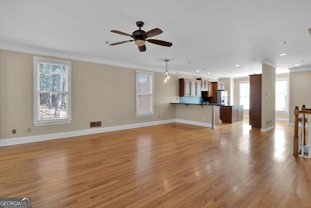 unfurnished living room with crown molding, light hardwood / wood-style floors, and ceiling fan