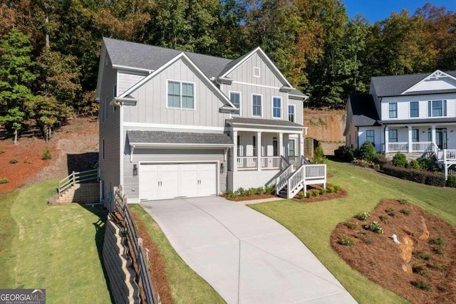 view of front of property featuring a garage, a front lawn, and a porch