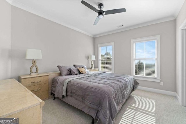 carpeted bedroom featuring ceiling fan and ornamental molding