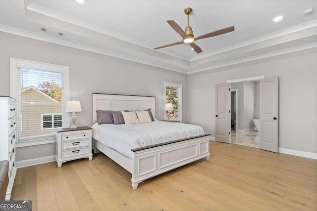 bedroom featuring ceiling fan, a raised ceiling, crown molding, and light hardwood / wood-style floors