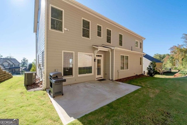 rear view of house featuring a yard, a patio area, and central AC