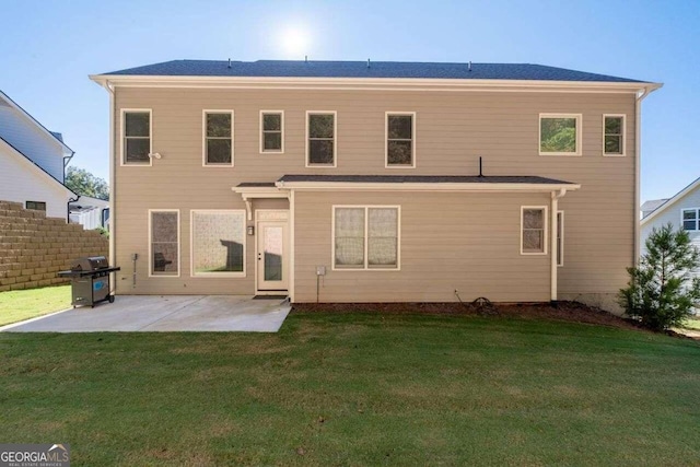 back of property featuring a lawn and a patio area