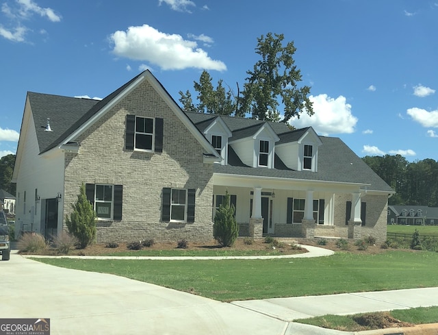 view of front of home with covered porch and a front yard