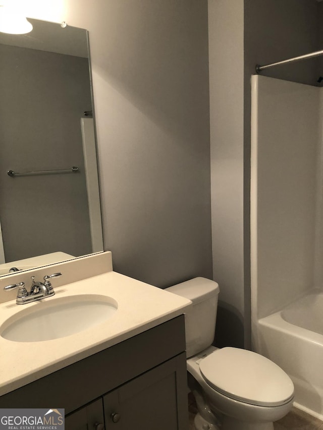 full bathroom with shower / bath combination, vanity, and toilet