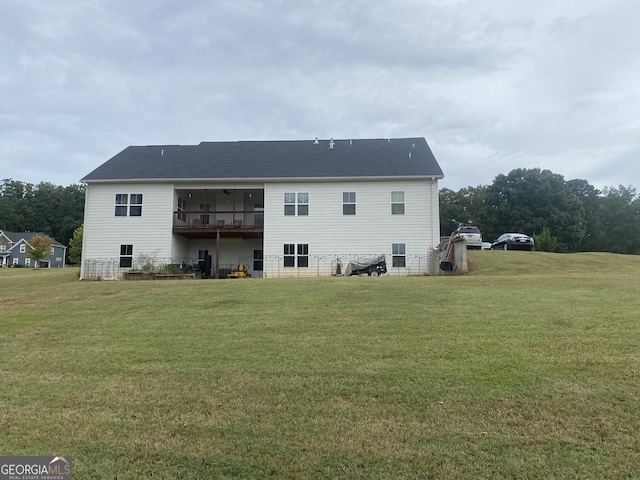 rear view of house featuring a yard