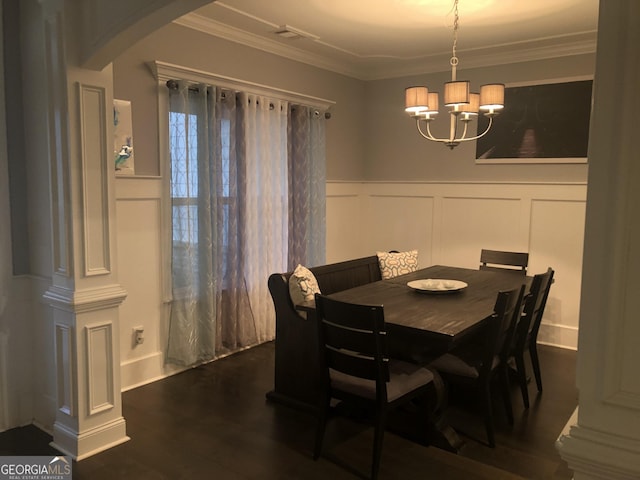 dining room with ornamental molding, dark hardwood / wood-style floors, and a chandelier