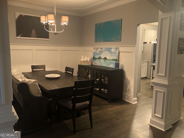 dining space featuring ornamental molding, dark hardwood / wood-style floors, and a chandelier