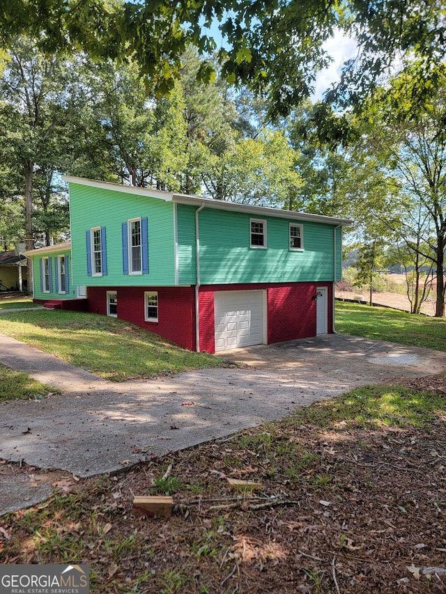 exterior space with a yard and a garage