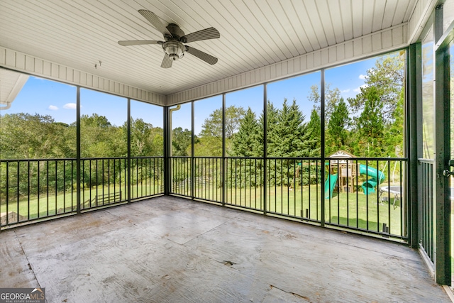 unfurnished sunroom with ceiling fan