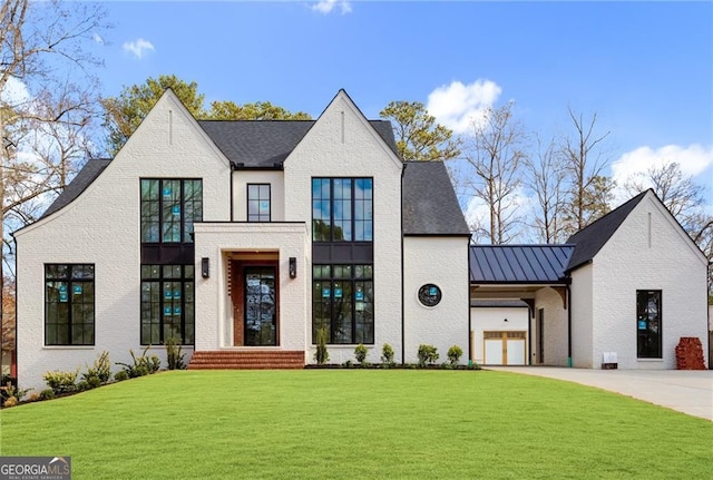 view of front of home featuring a garage and a front lawn