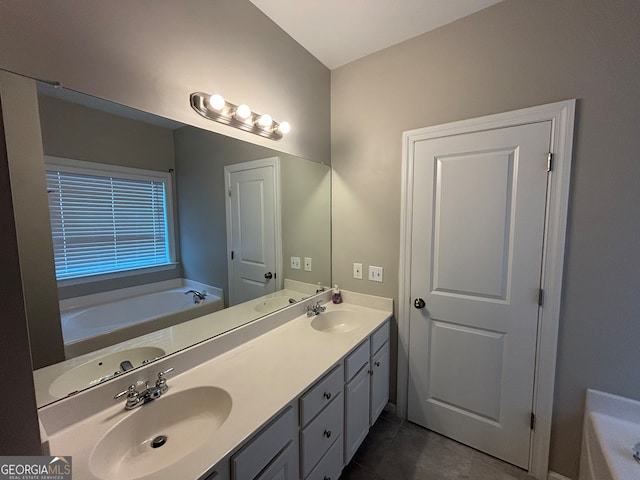 bathroom featuring vanity, a bathtub, and tile patterned flooring