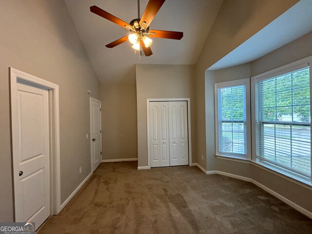 unfurnished bedroom with carpet floors, vaulted ceiling, and ceiling fan