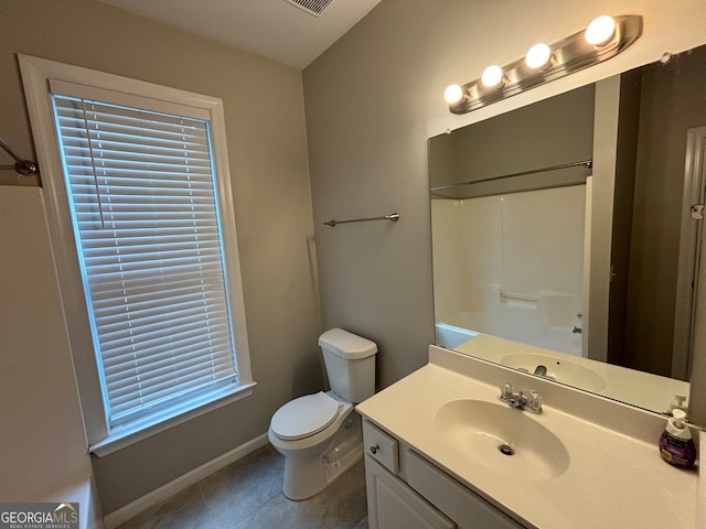 bathroom featuring tile patterned flooring, walk in shower, vanity, and toilet