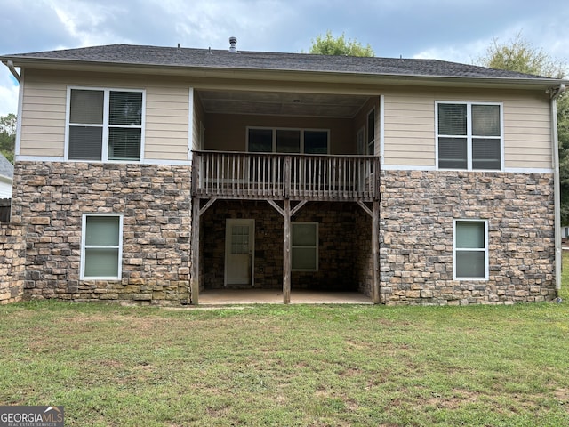 rear view of house featuring a balcony, a yard, and a patio