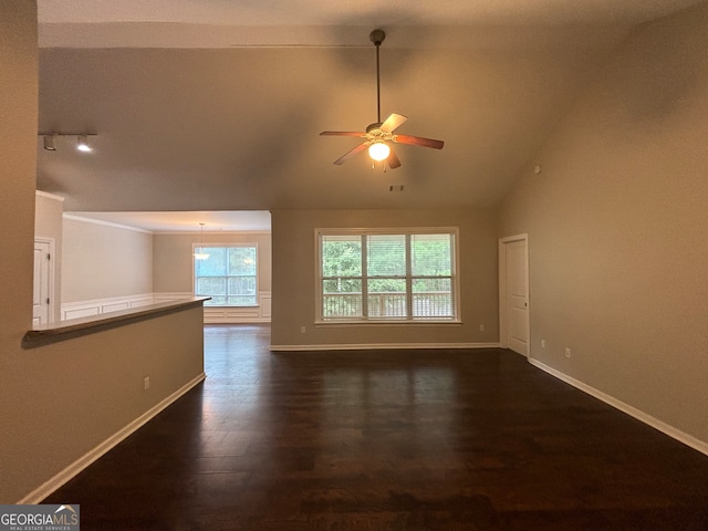 empty room featuring ceiling fan, lofted ceiling, and dark hardwood / wood-style flooring