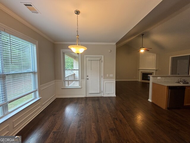 unfurnished dining area featuring ceiling fan, lofted ceiling, dark hardwood / wood-style flooring, and a healthy amount of sunlight