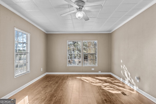 empty room with wood-type flooring, ceiling fan, and crown molding