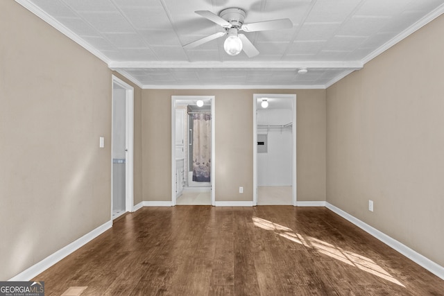 spare room featuring ceiling fan, wood-type flooring, and ornamental molding