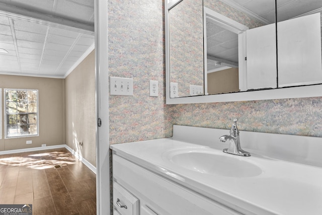 bathroom featuring vanity, wood-type flooring, and crown molding