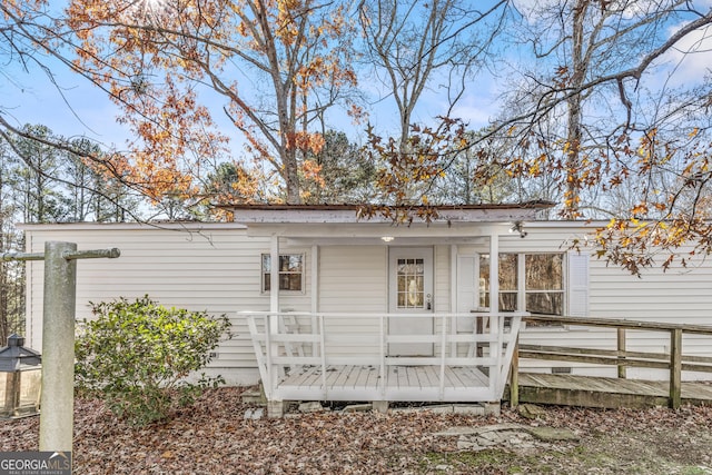 rear view of house with a wooden deck