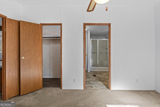 unfurnished bedroom with ceiling fan, crown molding, light carpet, and a closet