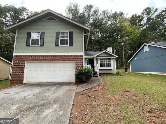 view of front of home with a front yard and a garage