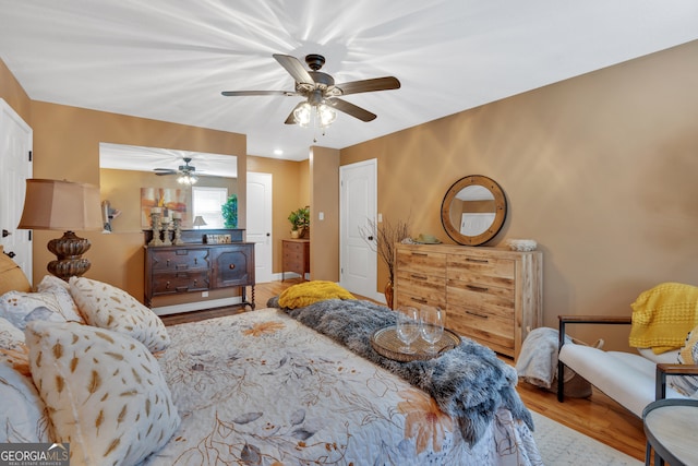 bedroom with ceiling fan and light hardwood / wood-style floors