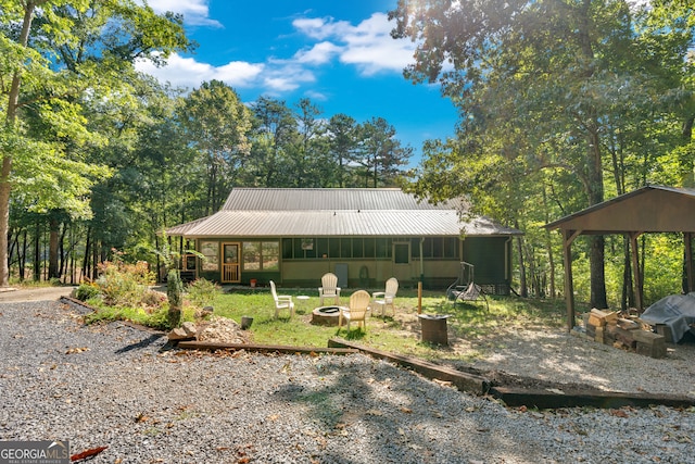 exterior space with a gazebo and a fire pit