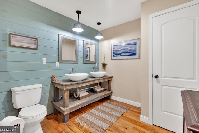 bathroom with wood-type flooring, vanity, and toilet