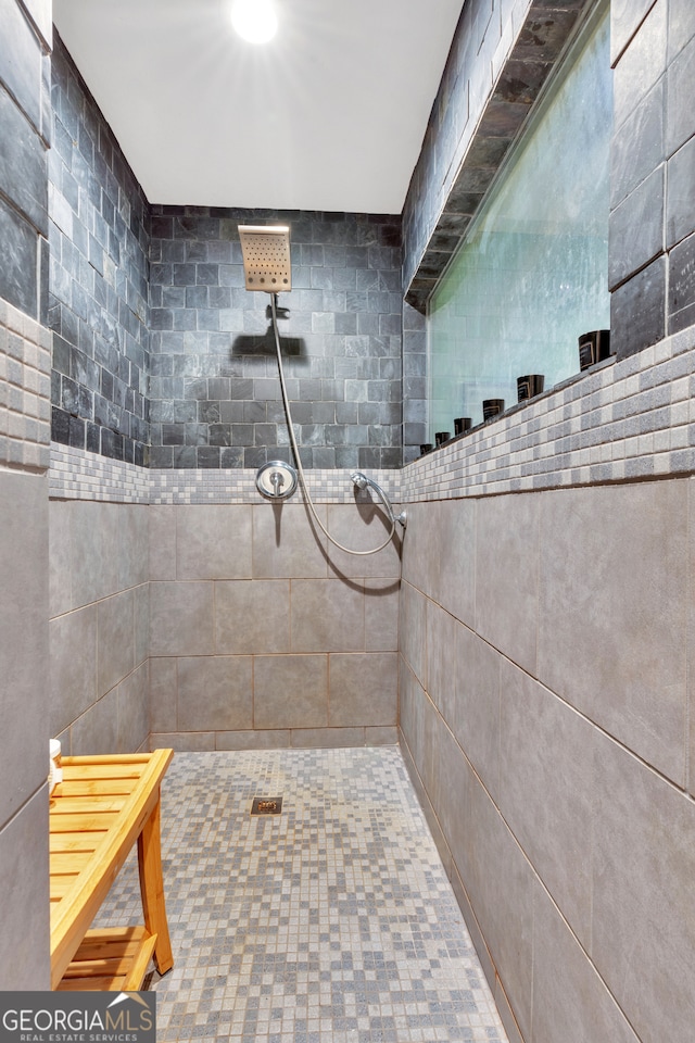 bathroom with a tile shower