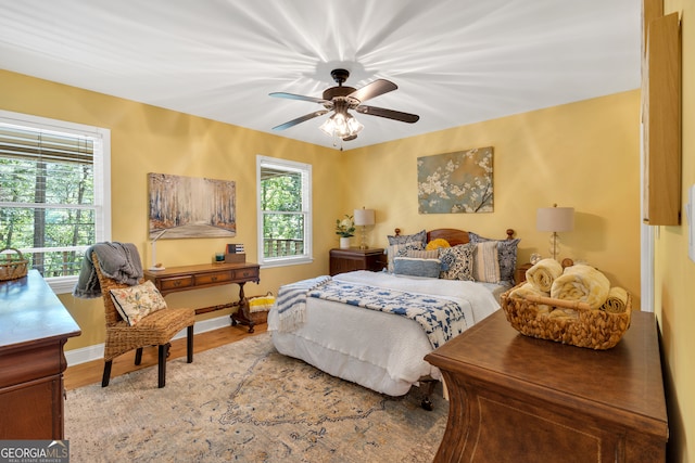 bedroom with ceiling fan and hardwood / wood-style floors