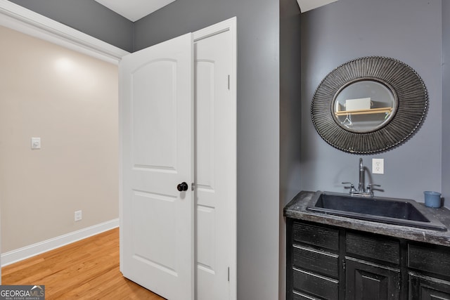 bathroom with wood-type flooring and vanity