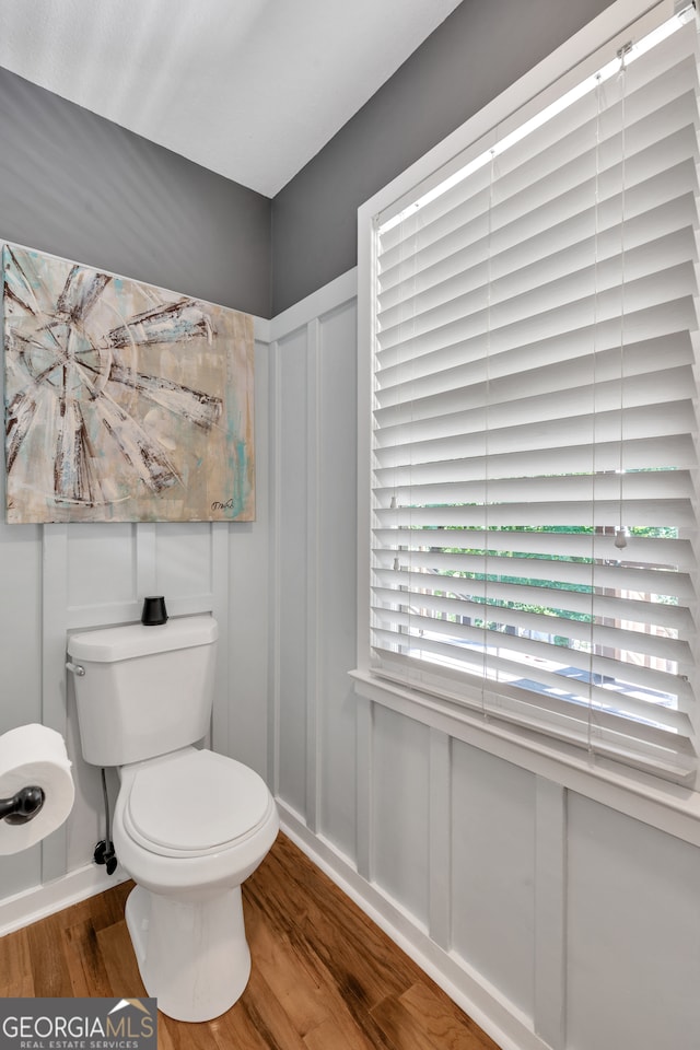 bathroom featuring hardwood / wood-style flooring and toilet