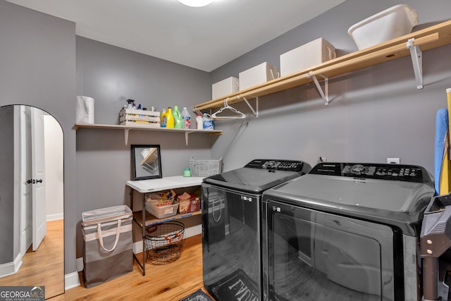 laundry room featuring light hardwood / wood-style floors and washer and dryer