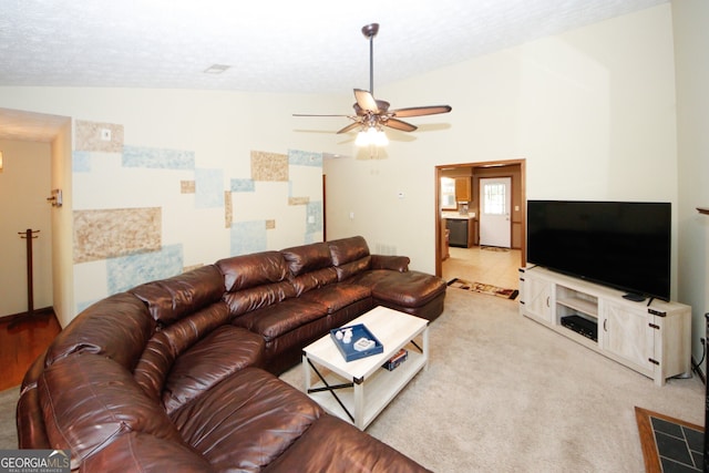 carpeted living room with lofted ceiling, a textured ceiling, and ceiling fan