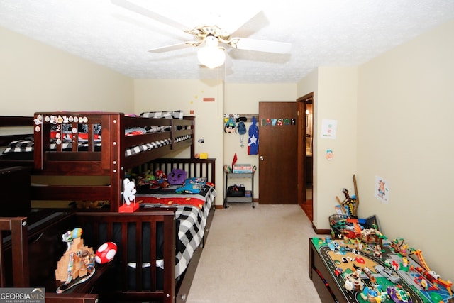 carpeted bedroom with a textured ceiling and ceiling fan