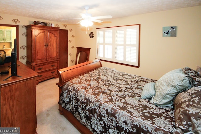 carpeted bedroom featuring a textured ceiling and ceiling fan