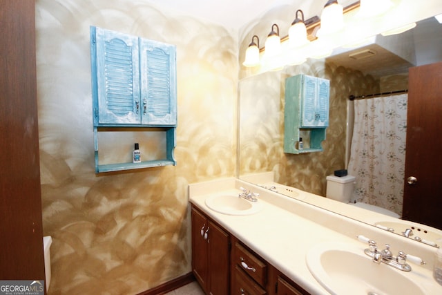 bathroom with vanity, toilet, and a shower with shower curtain