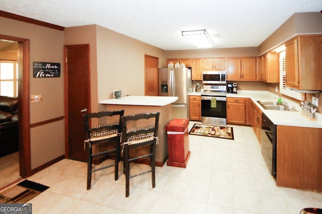 kitchen with ornamental molding, sink, and appliances with stainless steel finishes