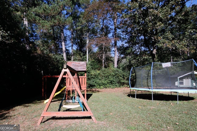 view of play area with a trampoline and a lawn