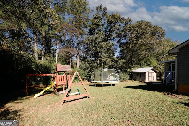 view of yard featuring a storage shed, a trampoline, and a playground