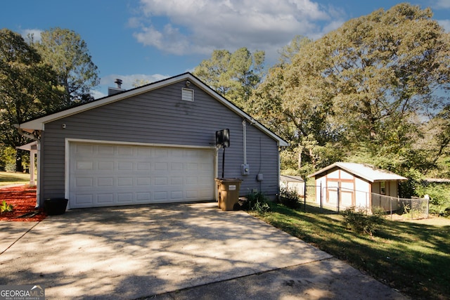 view of side of home with an outbuilding, a garage, and a lawn