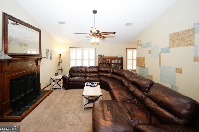 living room featuring vaulted ceiling, light carpet, a tiled fireplace, and plenty of natural light