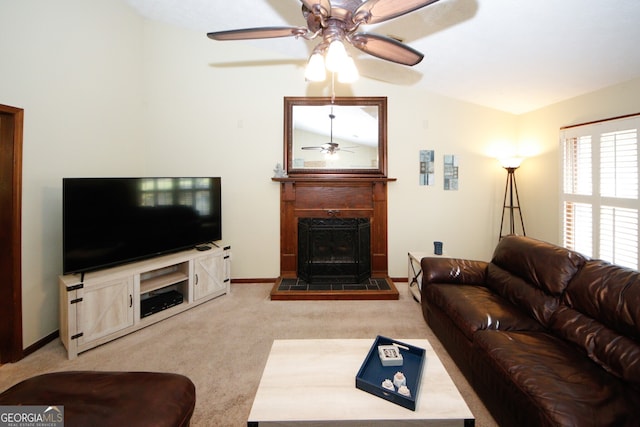 living room featuring carpet, vaulted ceiling, a fireplace, and ceiling fan