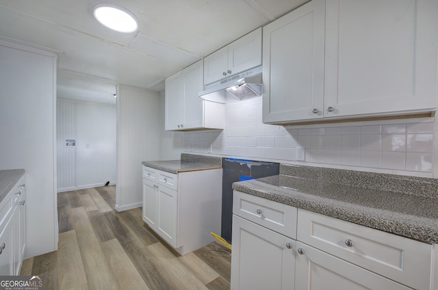 kitchen featuring light hardwood / wood-style floors, tasteful backsplash, and white cabinetry