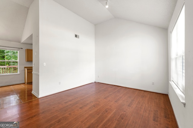 unfurnished room featuring dark hardwood / wood-style floors and high vaulted ceiling