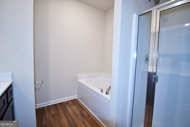 bathroom featuring shower with separate bathtub, vanity, and hardwood / wood-style flooring