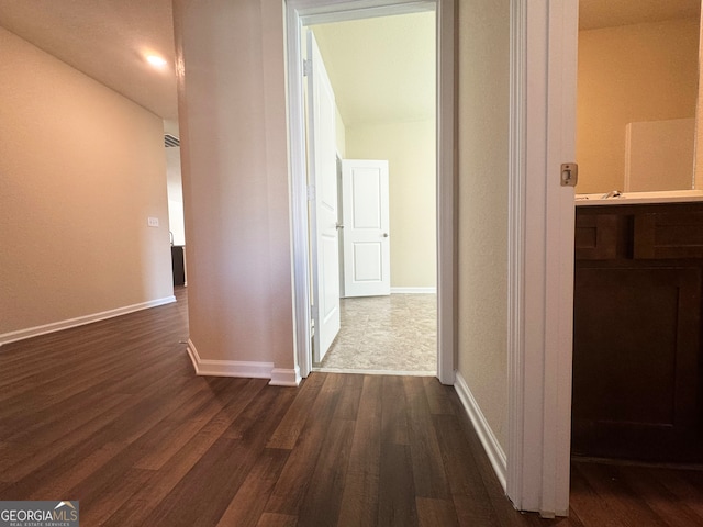 corridor featuring dark hardwood / wood-style flooring