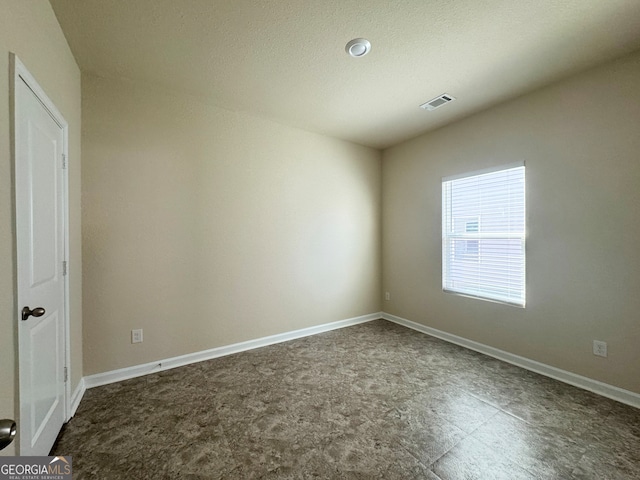 empty room featuring a textured ceiling