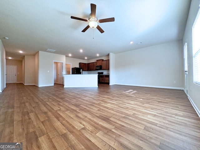 unfurnished living room with ceiling fan and light hardwood / wood-style floors